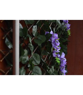Celosía exterior extensible con hiedra y flores lila decorativas.